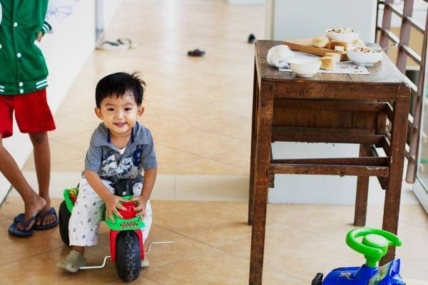 Young boy riding on a bike.