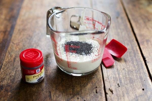 Poppy seeds and liquid in a measuring cup.
