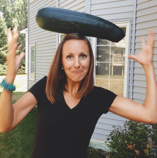 Giant Zucchini on a woman's head.