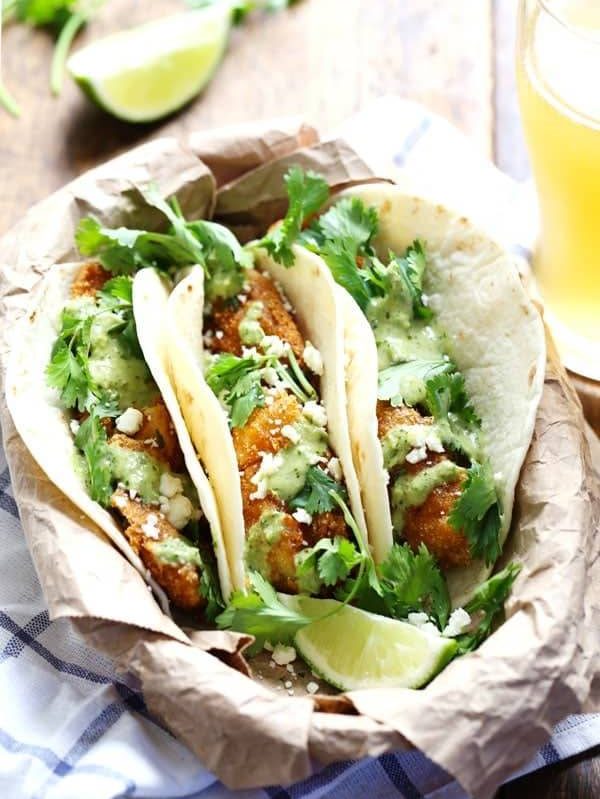 Crispy Fish Tacos with Jalapeño Sauce - beer-battered with a cornmeal crust for an extra yummy texture, plus the spicy-cool combo of that creamy jalapeño sauce. Summer food! | pinchofyum.com