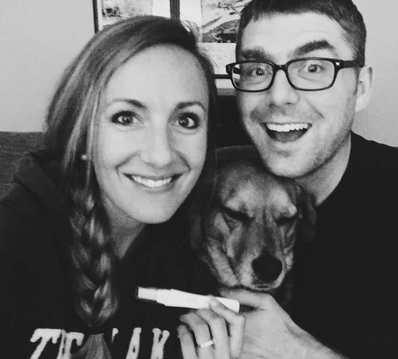 A happy couple with their dog.