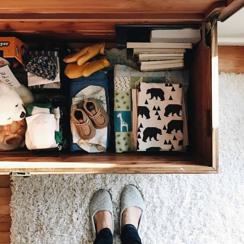 A chest containing books, boots, gloves and other apparel.