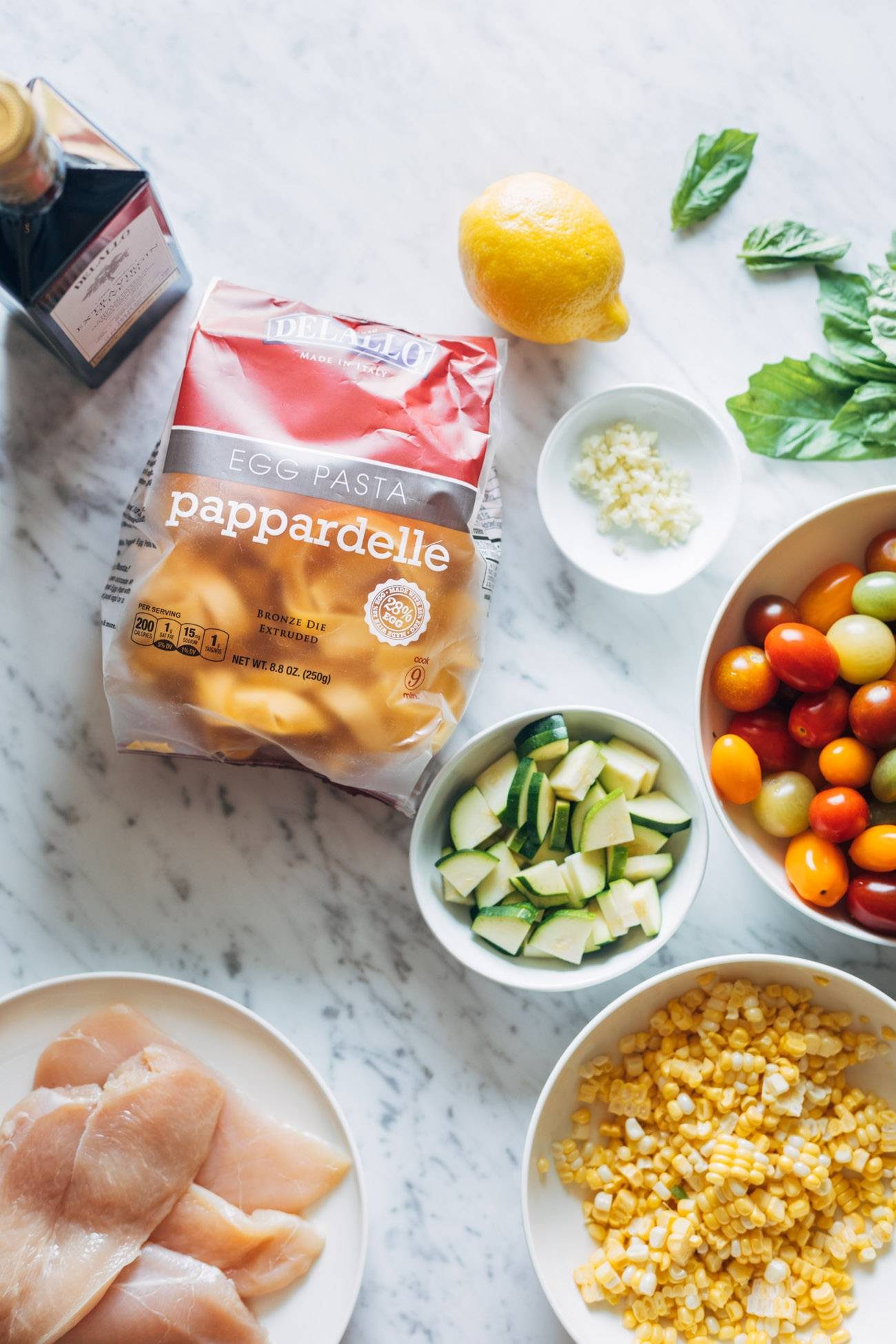 Overhead image of ingredients for Burst Tomato Pappardelle. 