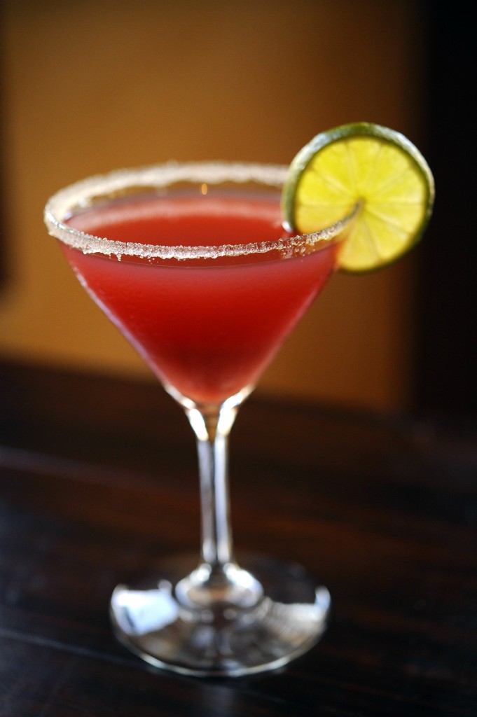 Kouzzina Ouzo-tini featuring Absolut vodka, Metaxa ouzo, pineapple juice, fresh lime juice and pomegranate served in a sugar-rimmed martini glass shaken and served tableside