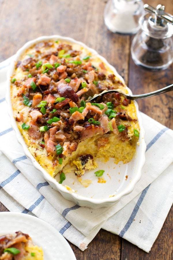 Ham and Sausage Hash Brown Egg Bake with a spoon.