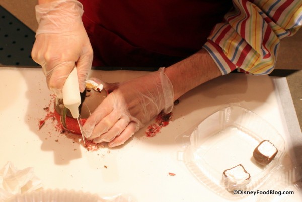 Cast Member slicing the apple
