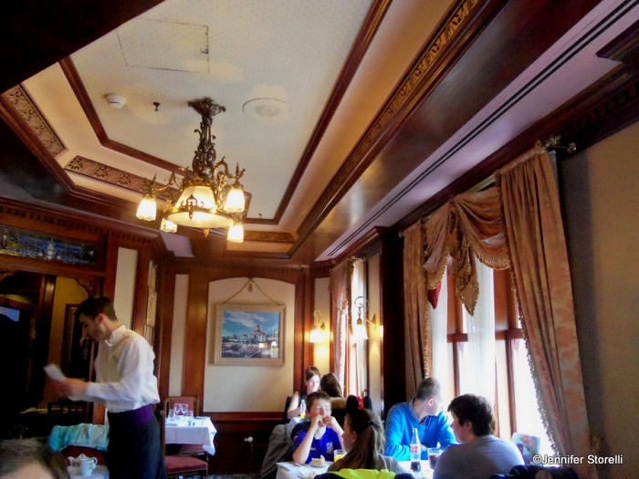 The Disneyland Hotel room is a cozy parlor overlooking Main Street, U.S.A.