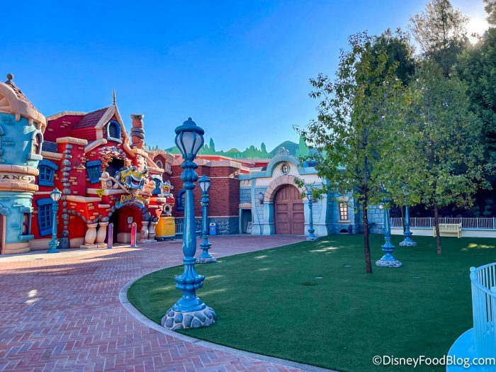 brick street with cartoon like building and light poles