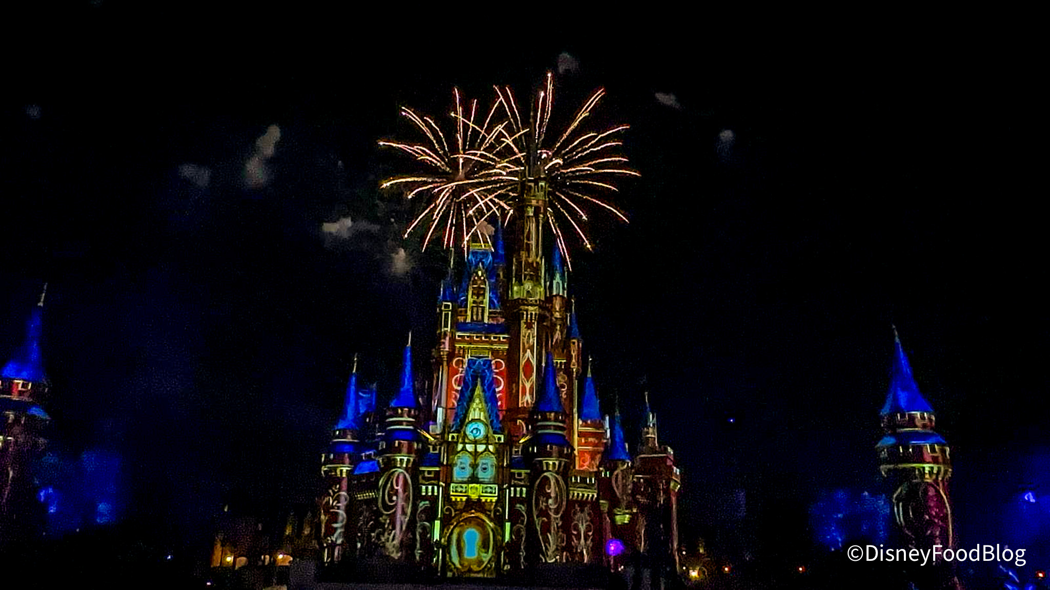 castle projections in bright colors and white firework on top