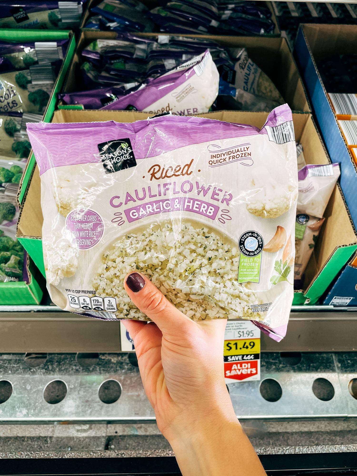 White hand holding a bag of cauliflower rice