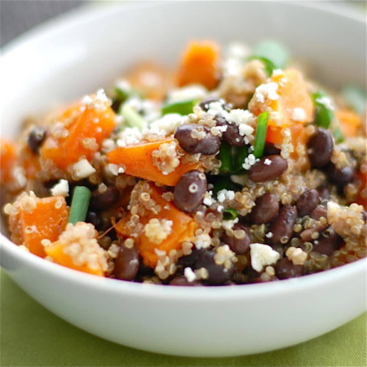Butternut squash black bean wrap dissembled in a white bowl on a green napkin.