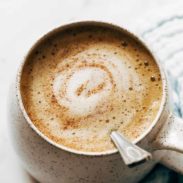 Honey oatmilk latte with a spoon in it.