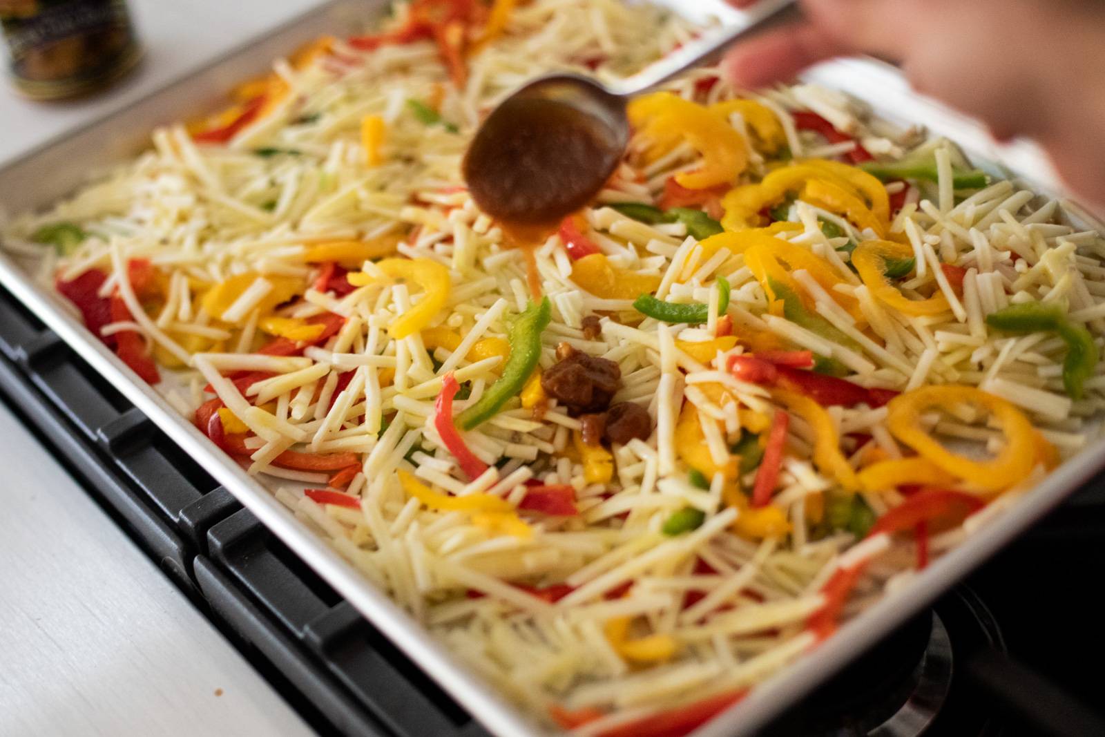 Veggies and bouillon paste on a sheet pan.