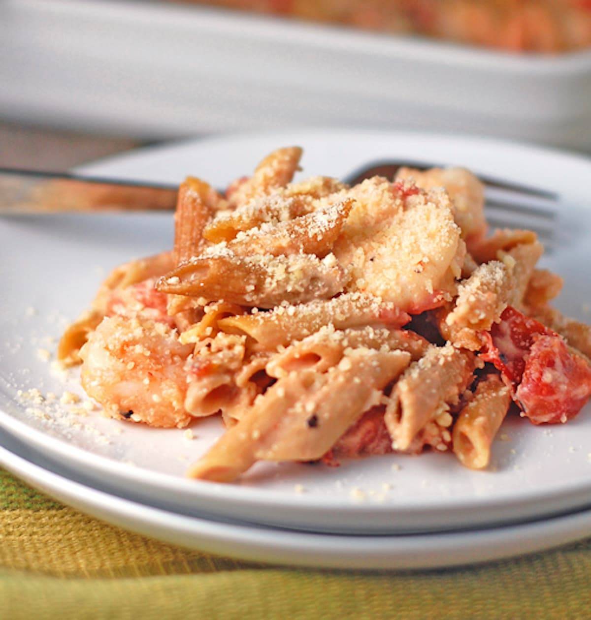 Garlic shrimp baked penne on a plate with a fork.
